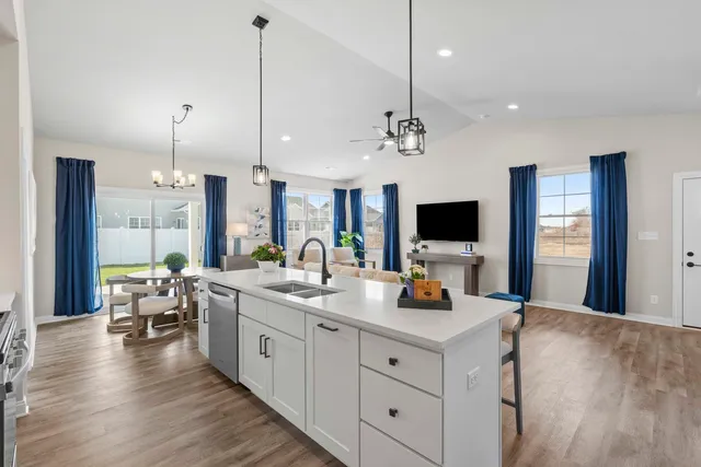 a large kitchen with sink and view of living room
