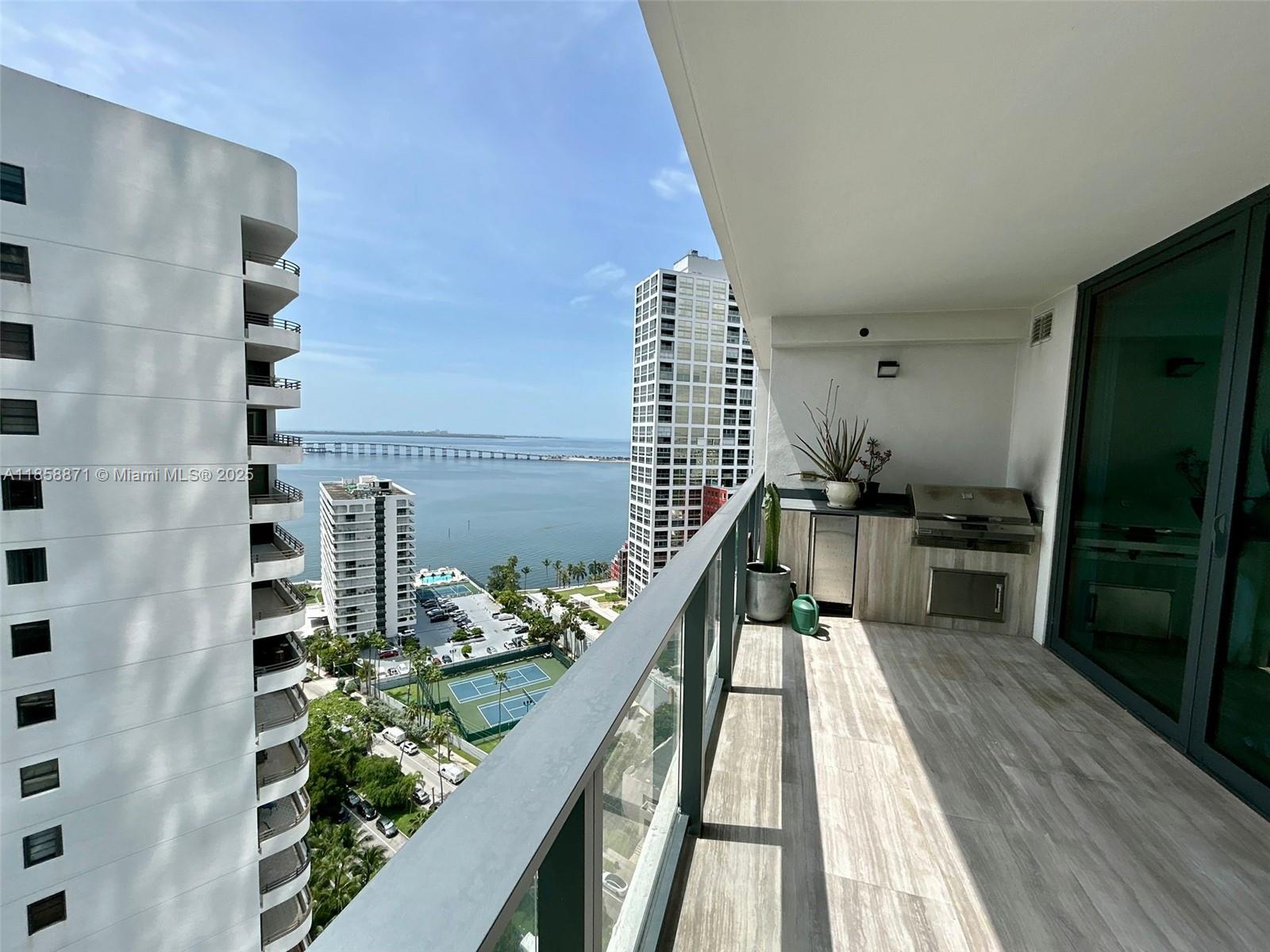 1451 Brickell Avenue, Unit 2102 Miami, FL 33131 - Photo 4 of 14 a view of a balcony with wooden floor and seating