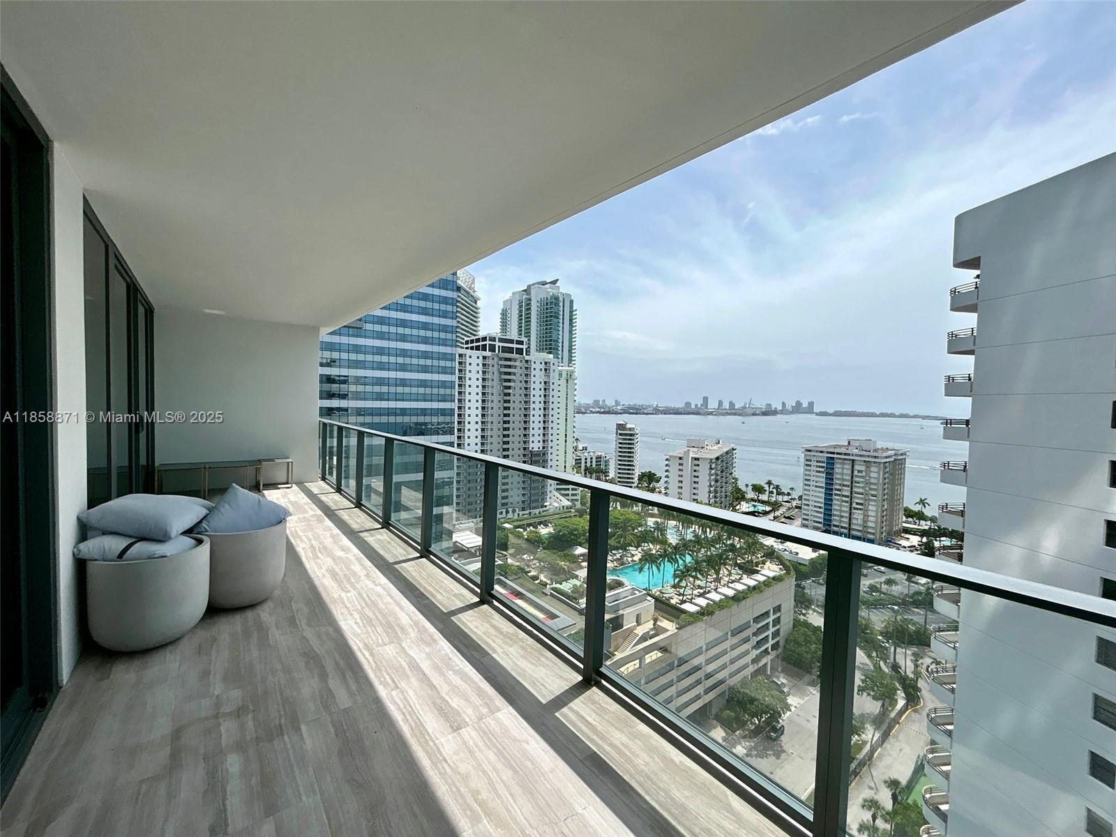 1451 Brickell Avenue, Unit 2102 Miami, FL 33131 - Photo 5 of 14 a balcony with hardwood filled table and chairs