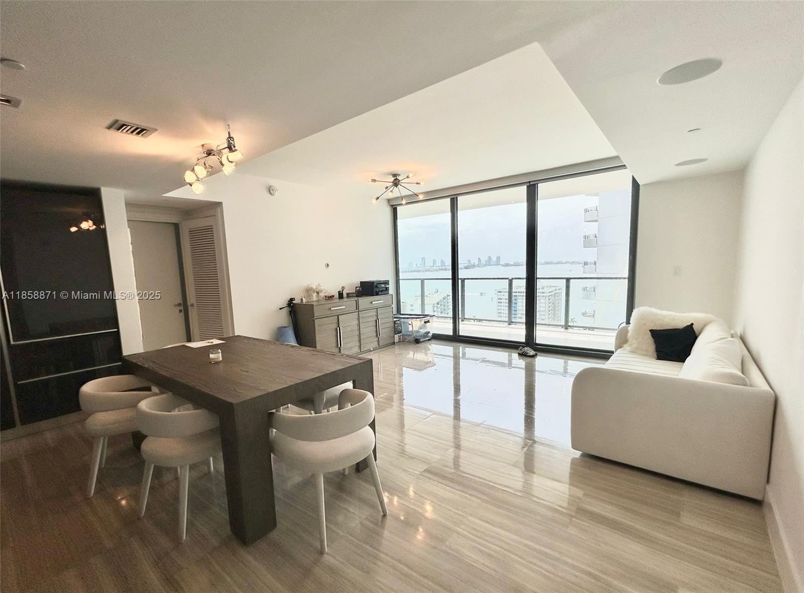 1451 Brickell Avenue, Unit 2102 Miami, FL 33131 - Photo 7 of 14 a view of a dining room with furniture and a large window