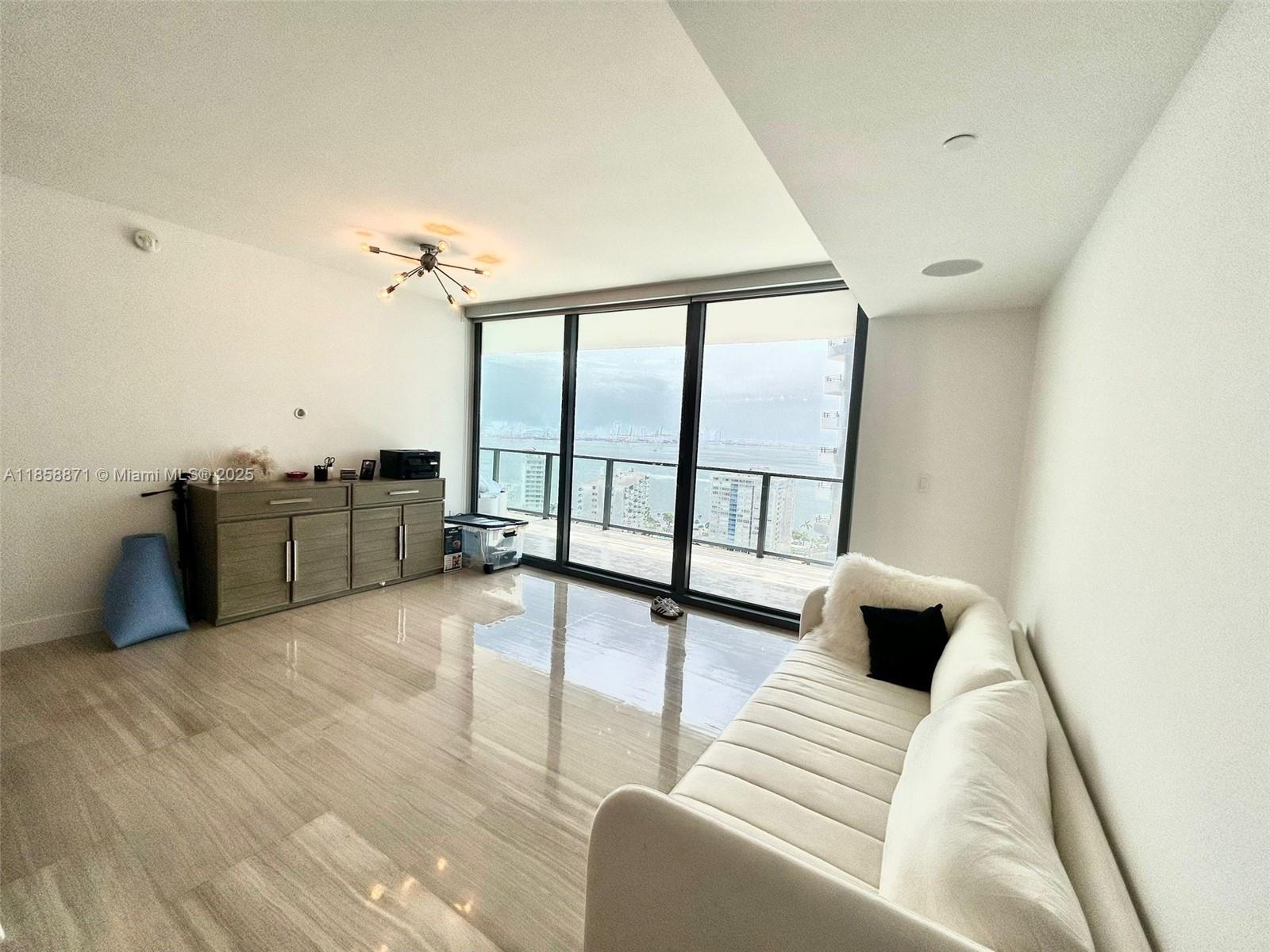 1451 Brickell Avenue, Unit 2102 Miami, FL 33131 - Photo 8 of 14 a view of a living room hardwood floor and a ceiling fan