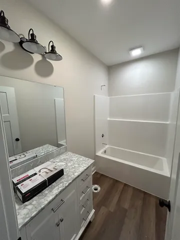 a bathroom with a tub and a sink
