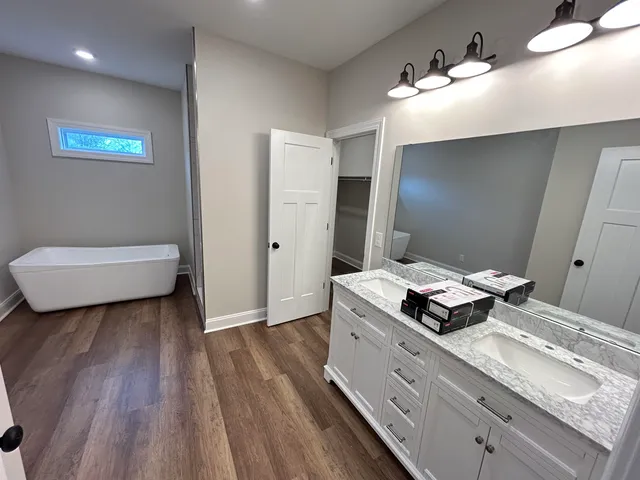 a spacious bathroom with a granite countertop sink and a mirror