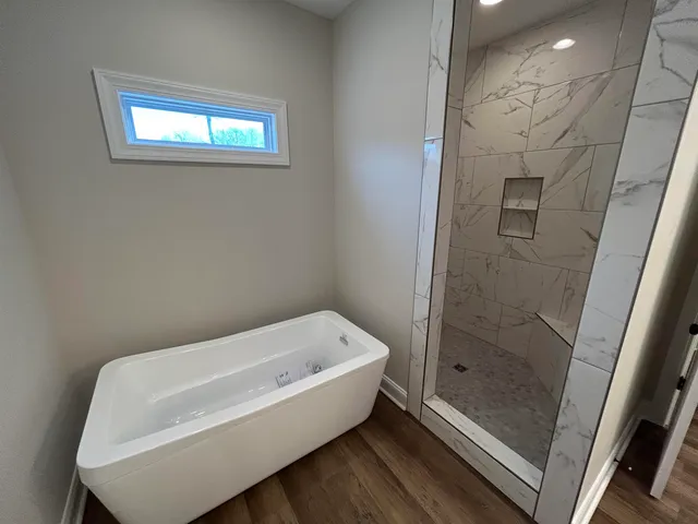 a bathroom with a bathtub and shower