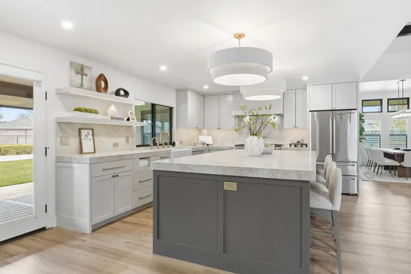 a kitchen with a stove sink and cabinets