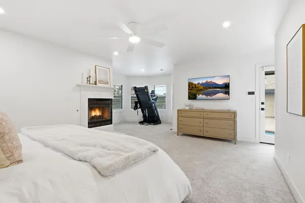 a view of an empty room with a window and fireplace