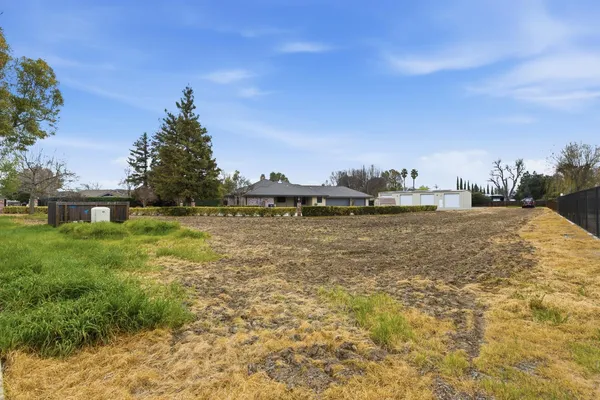 an aerial view of a house with a yard and lake view