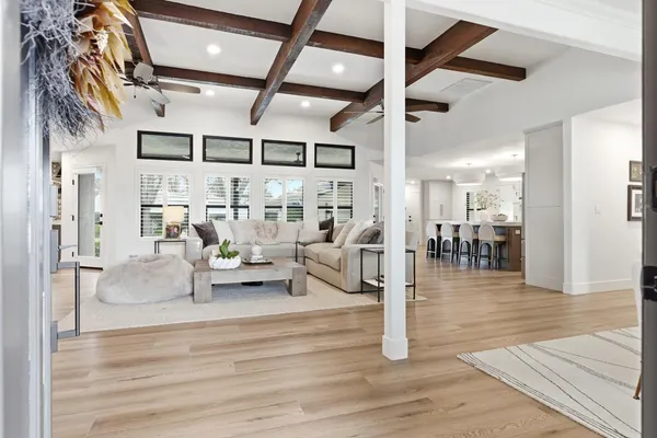 a living room with furniture and kitchen view