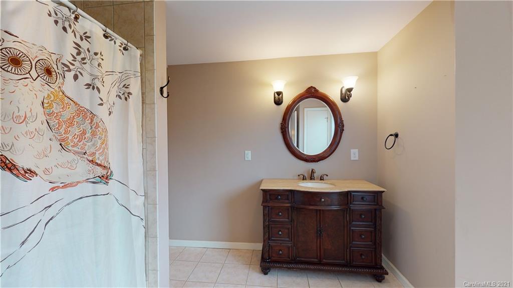 960 George Brown Road Crouse, NC 28033 - Photo 29 of 31 a bathroom with a sink a mirror and a shower curtain
