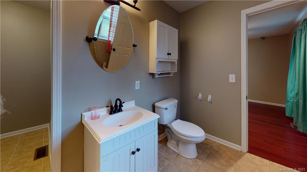 960 George Brown Road Crouse, NC 28033 - Photo 30 of 31 a bathroom with a toilet a sink and mirror