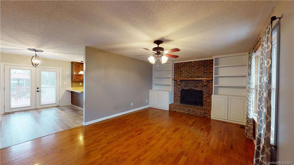 960 George Brown Road Crouse, NC 28033 - Photo 5 of 31 a view of a livingroom with wooden floor and a kitchen