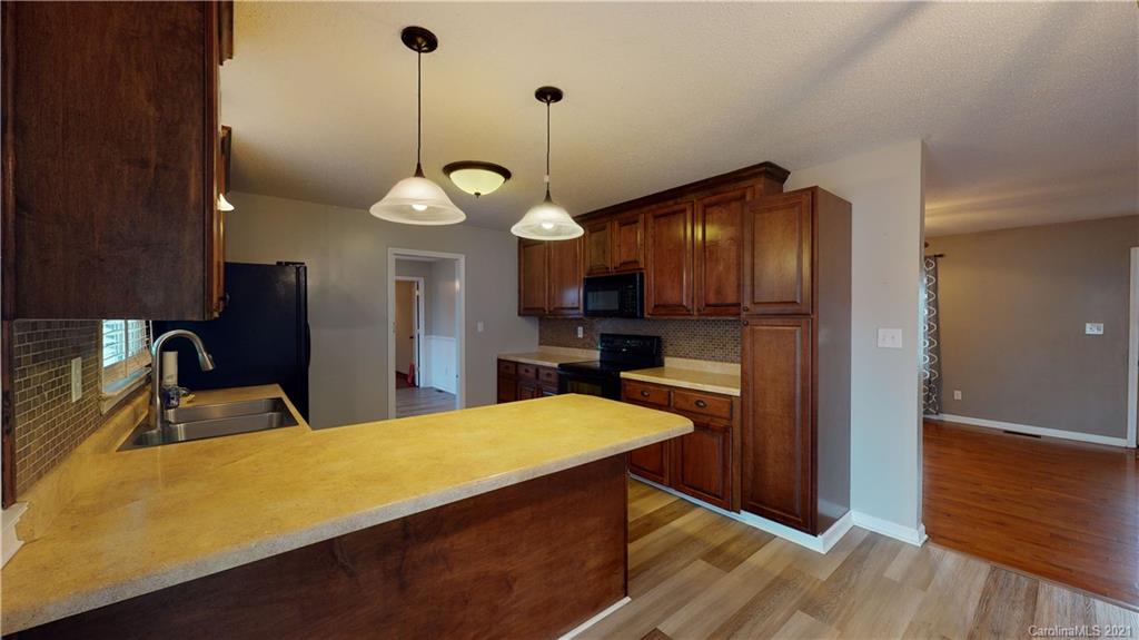 960 George Brown Road Crouse, NC 28033 - Photo 10 of 31 a kitchen with a refrigerator a sink and wooden floor