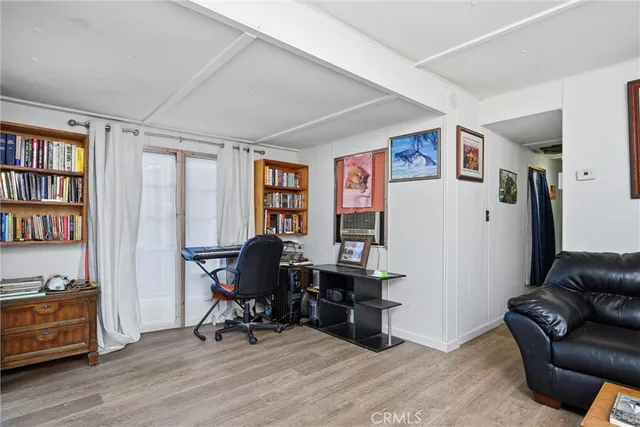 a view of a livingroom with workspace and a window