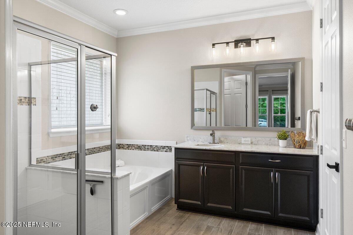 174 Beartooth Trail Ponte Vedra, FL 32081 - Photo 7 of 29 a bathroom with a double vanity sink and mirror with bathtub