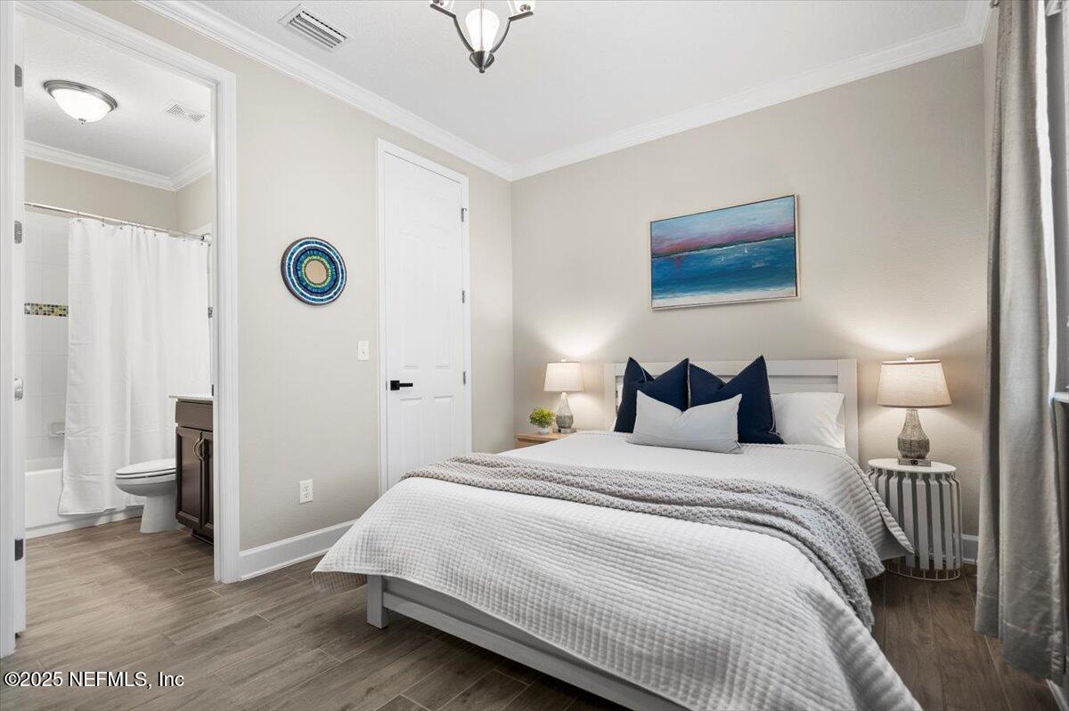 174 Beartooth Trail Ponte Vedra, FL 32081 - Photo 9 of 29 a bedroom with a bed and a mirror