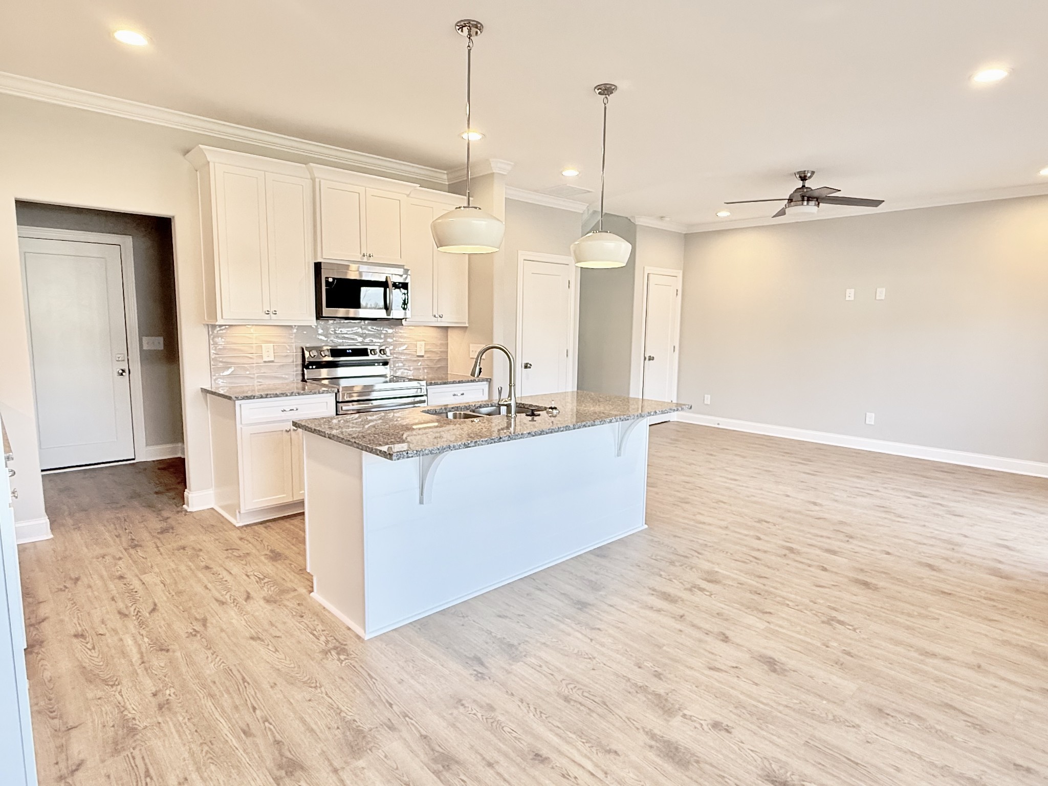 1917 Gracie Bug Loop Murfreesboro, TN 37128 - Photo 3 of 27 a large kitchen with kitchen island a sink stainless steel appliances and cabinets
