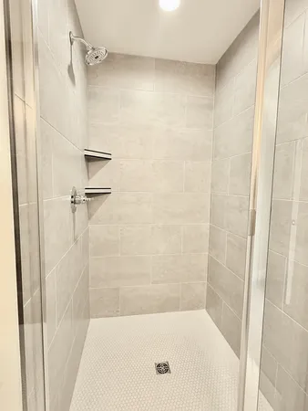 a bathroom with a shower and a bath tub