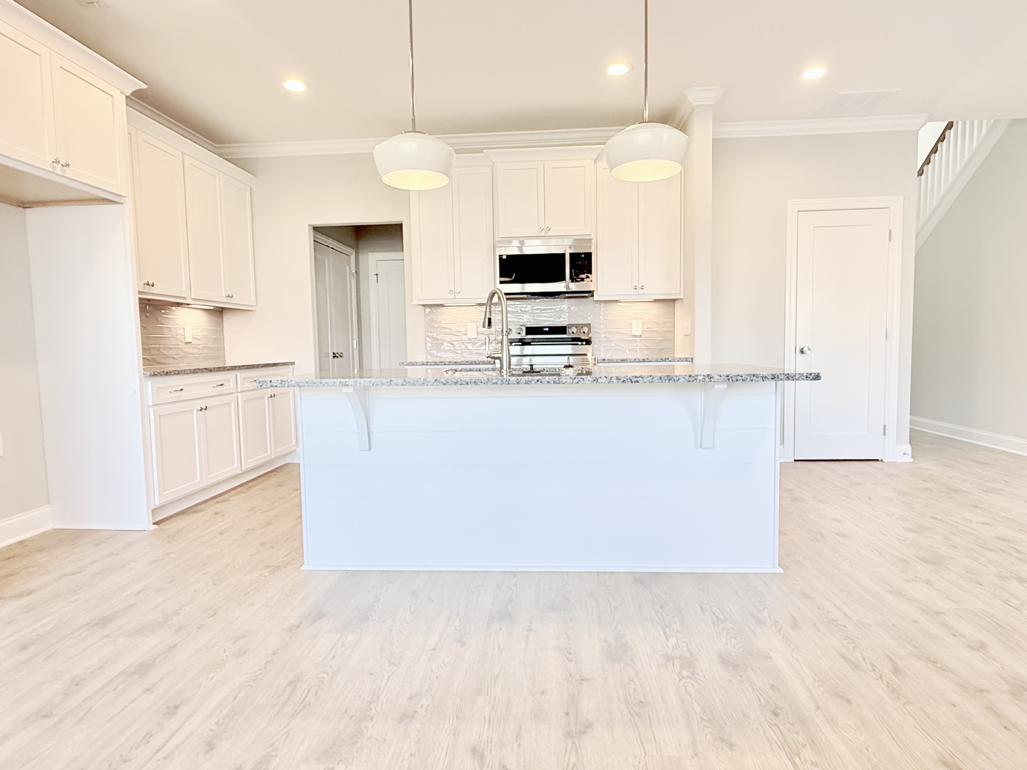 1917 Gracie Bug Loop Murfreesboro, TN 37128 - Photo 10 of 27 a large kitchen with stainless steel appliances granite countertop a stove a sink and a refrigerator