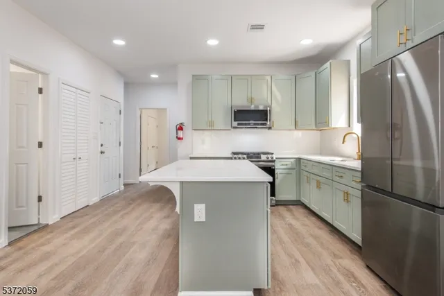 a kitchen with a refrigerator sink and stove