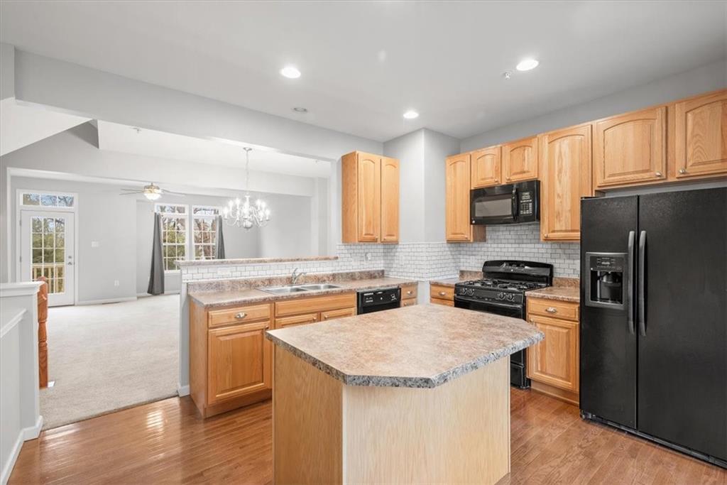 115 Lewisham Road Cranberry Township, PA 16066 - Photo 5 of 38 a kitchen with a sink a stove a refrigerator and a microwave