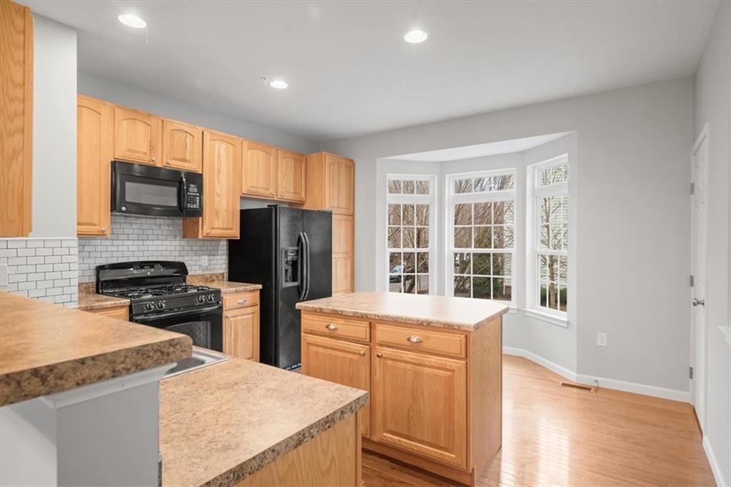 115 Lewisham Road Cranberry Township, PA 16066 - Photo 8 of 38 a kitchen with a sink a stove and a refrigerator
