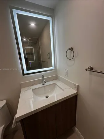 a bathroom with a sink vanity and mirror