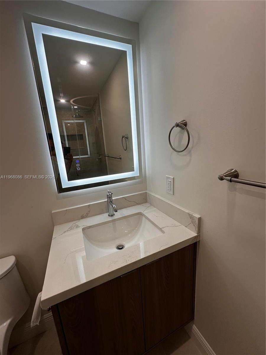 1900 West 54th Street, Unit 219 Hialeah, FL 33012 - Photo 11 of 42 a bathroom with a sink vanity and mirror
