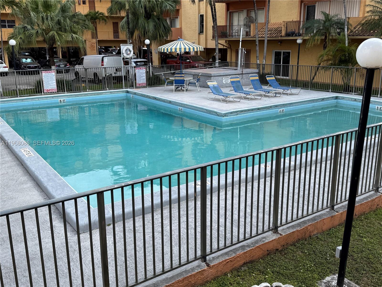 1900 West 54th Street, Unit 219 Hialeah, FL 33012 - Photo 18 of 42 a view of swimming pool with outdoor seating
