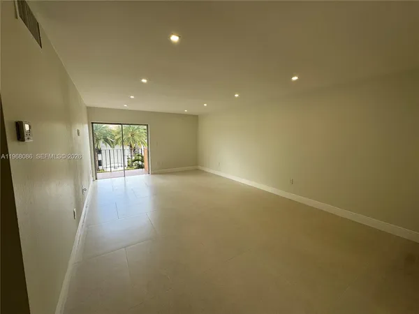 an empty room with windows and entrance