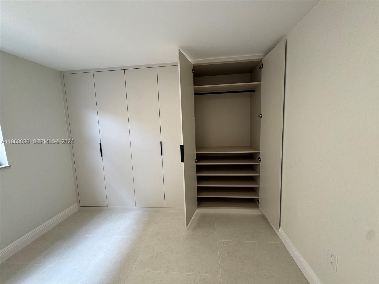 1900 West 54th Street, Unit 219 Hialeah, FL 33012 - Photo 21 of 42 a view of walk in closet with empty racks