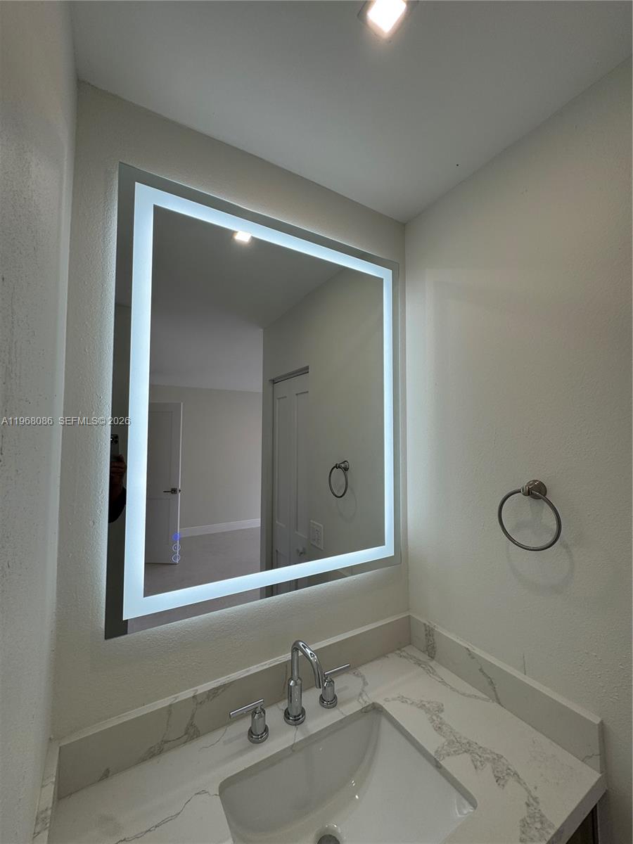 1900 West 54th Street, Unit 219 Hialeah, FL 33012 - Photo 26 of 42 a bathroom with a sink and a mirror