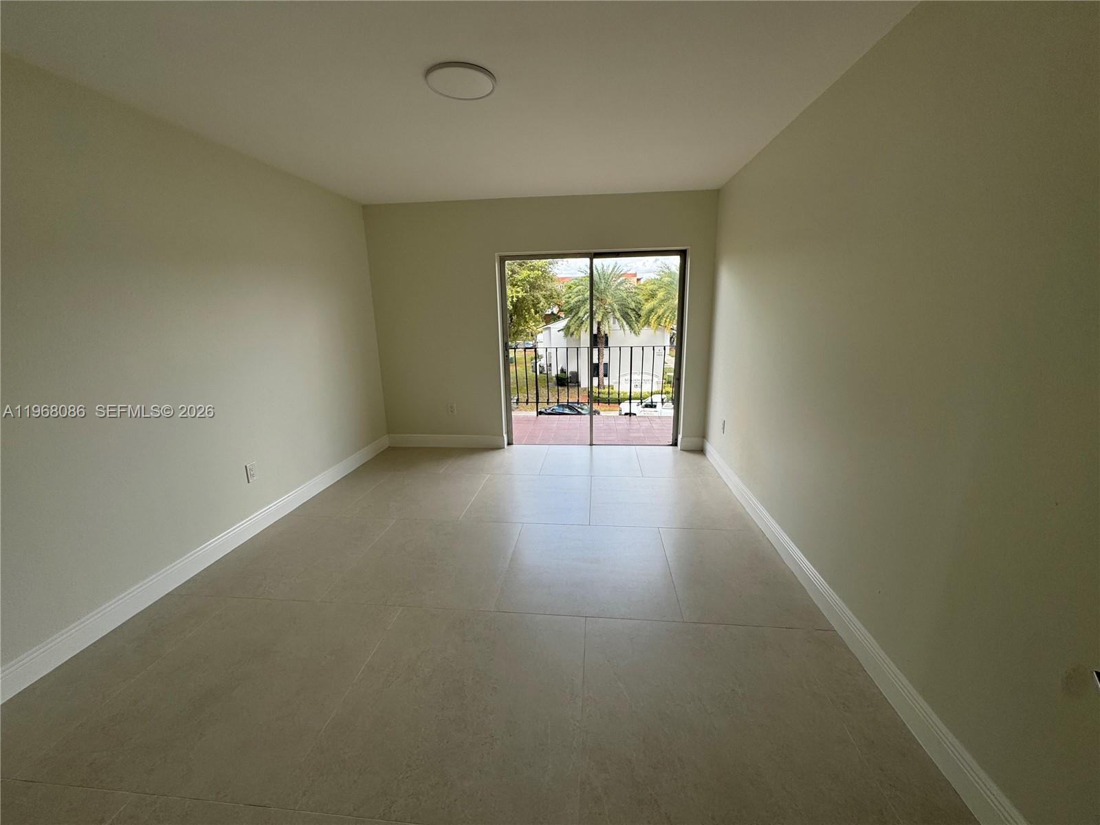 1900 West 54th Street, Unit 219 Hialeah, FL 33012 - Photo 9 of 42 an empty room with wooden floor and windows