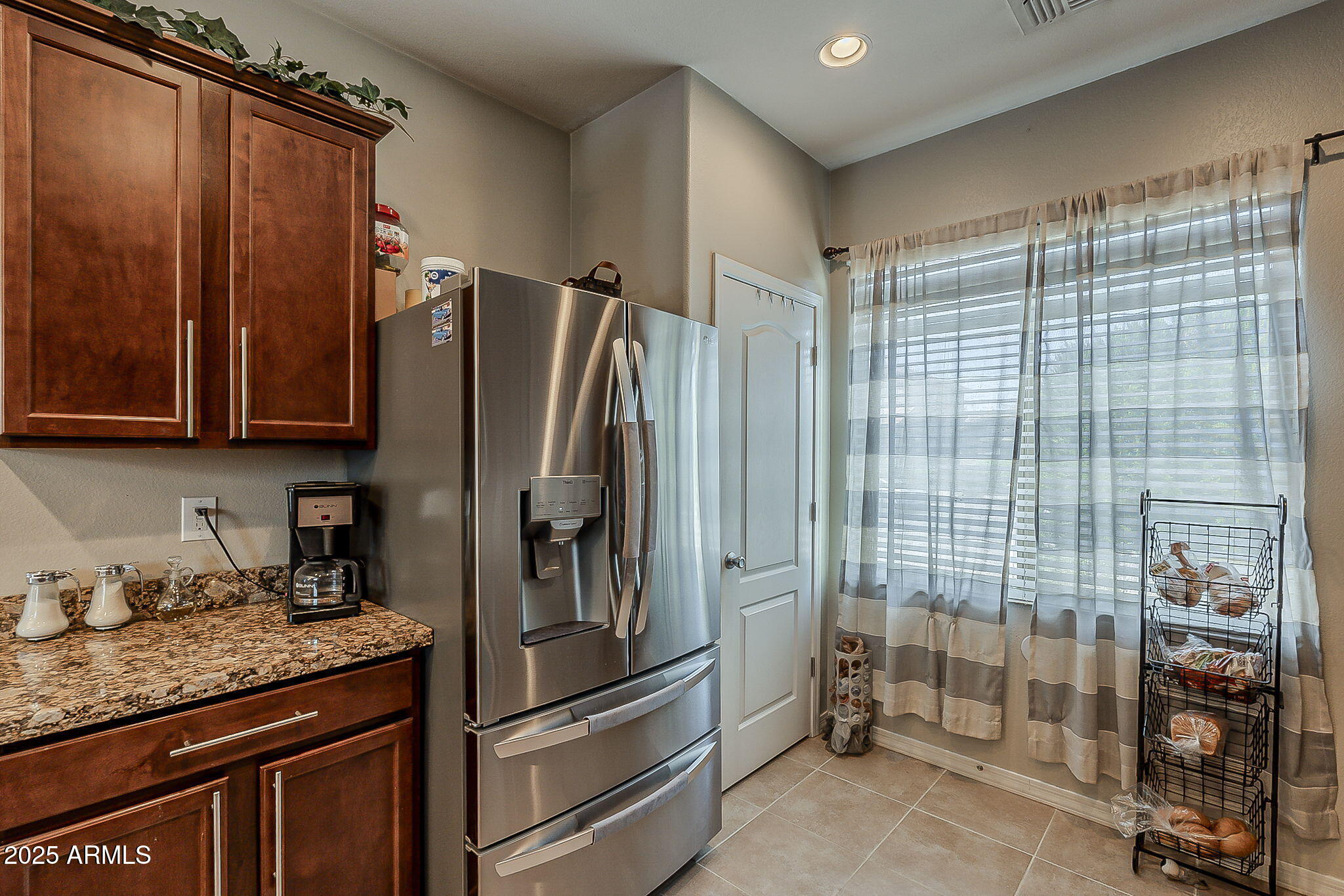 4407 West Crescent Road San Tan Valley, AZ 85144 - Photo 13 of 50 a kitchen with stainless steel appliances granite countertop a refrigerator and a sink