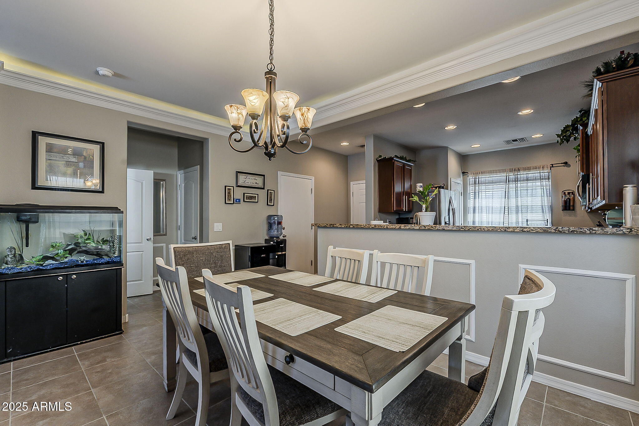 4407 West Crescent Road San Tan Valley, AZ 85144 - Photo 17 of 50 a view of a dining room and livingroom with furniture a rug a rug and a chandelier