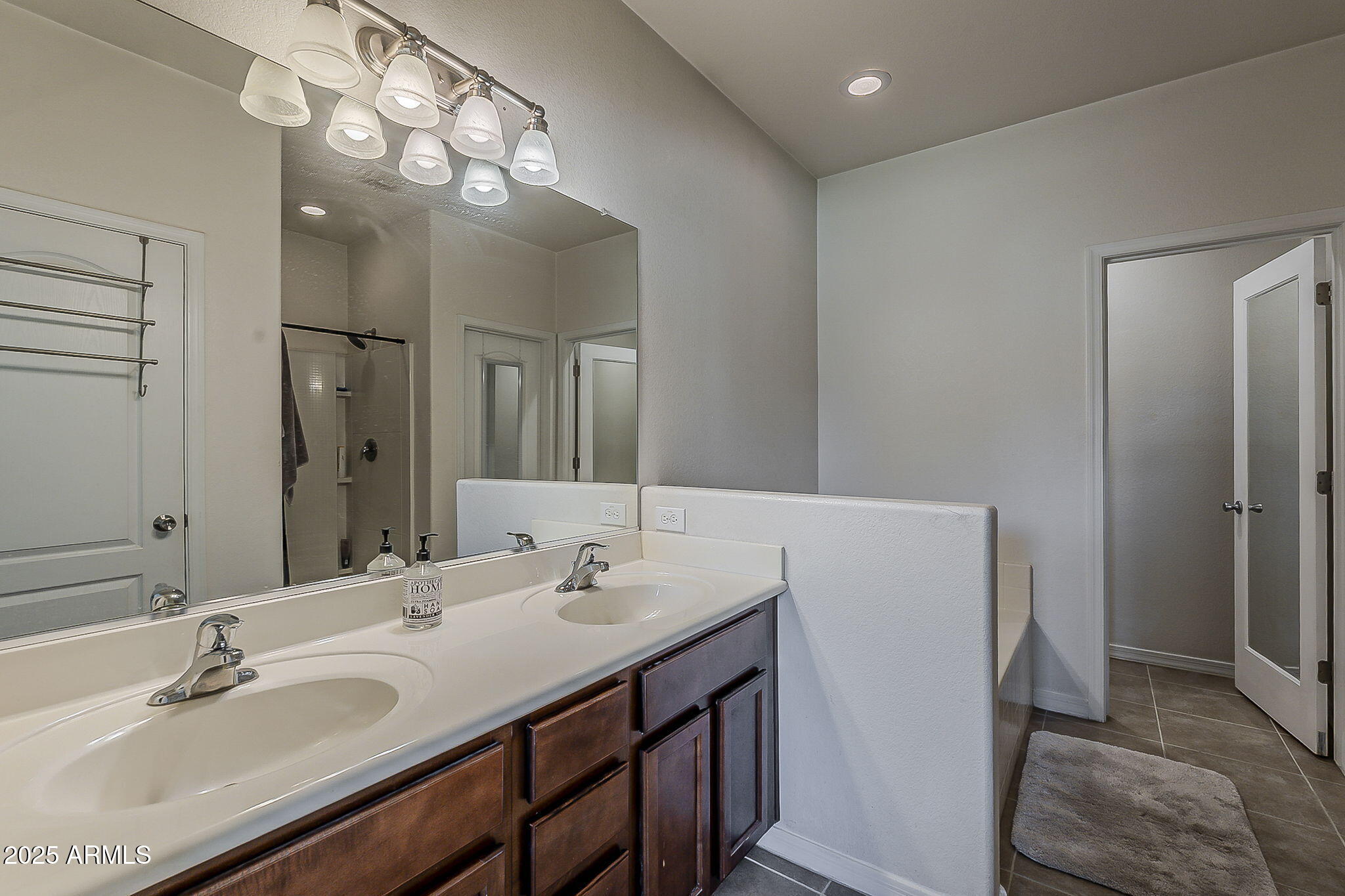 4407 West Crescent Road San Tan Valley, AZ 85144 - Photo 25 of 50 a bathroom with a double vanity sink and a mirror