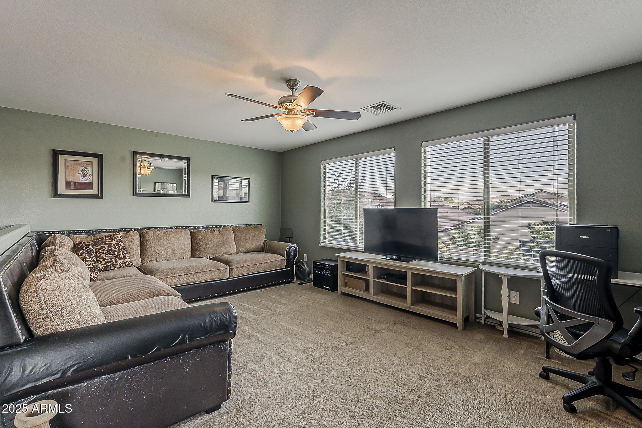 4407 West Crescent Road San Tan Valley, AZ 85144 - Photo 29 of 50 a living room with furniture a flat screen tv and gym equipment