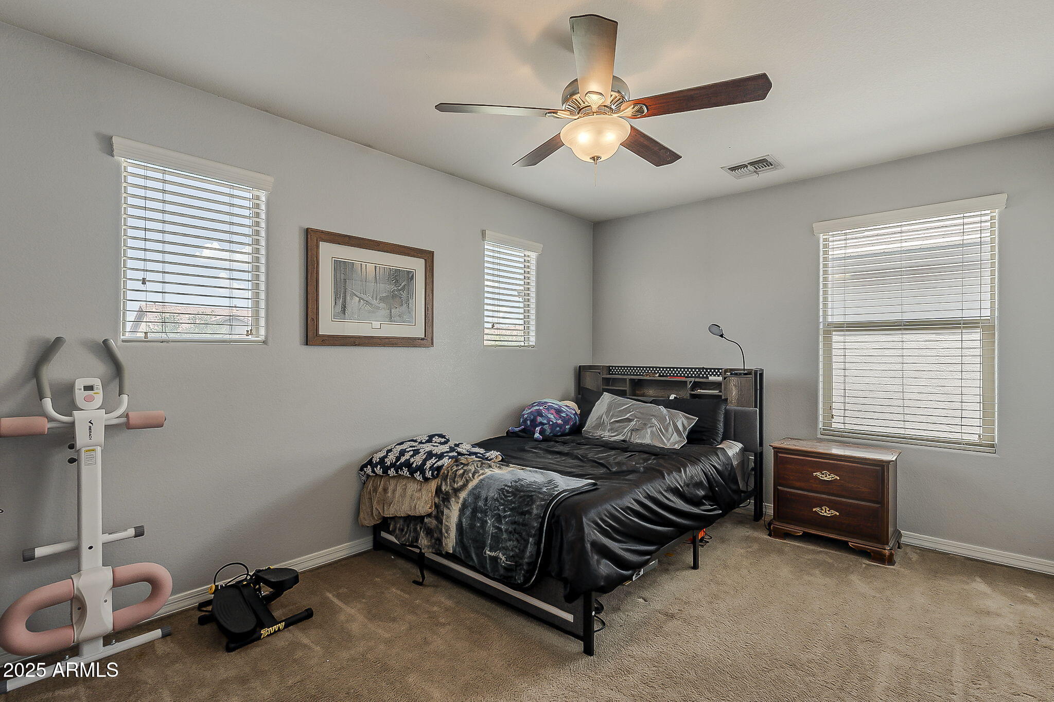 4407 West Crescent Road San Tan Valley, AZ 85144 - Photo 32 of 50 a spacious bedroom with a bed a chandelier and a dresser