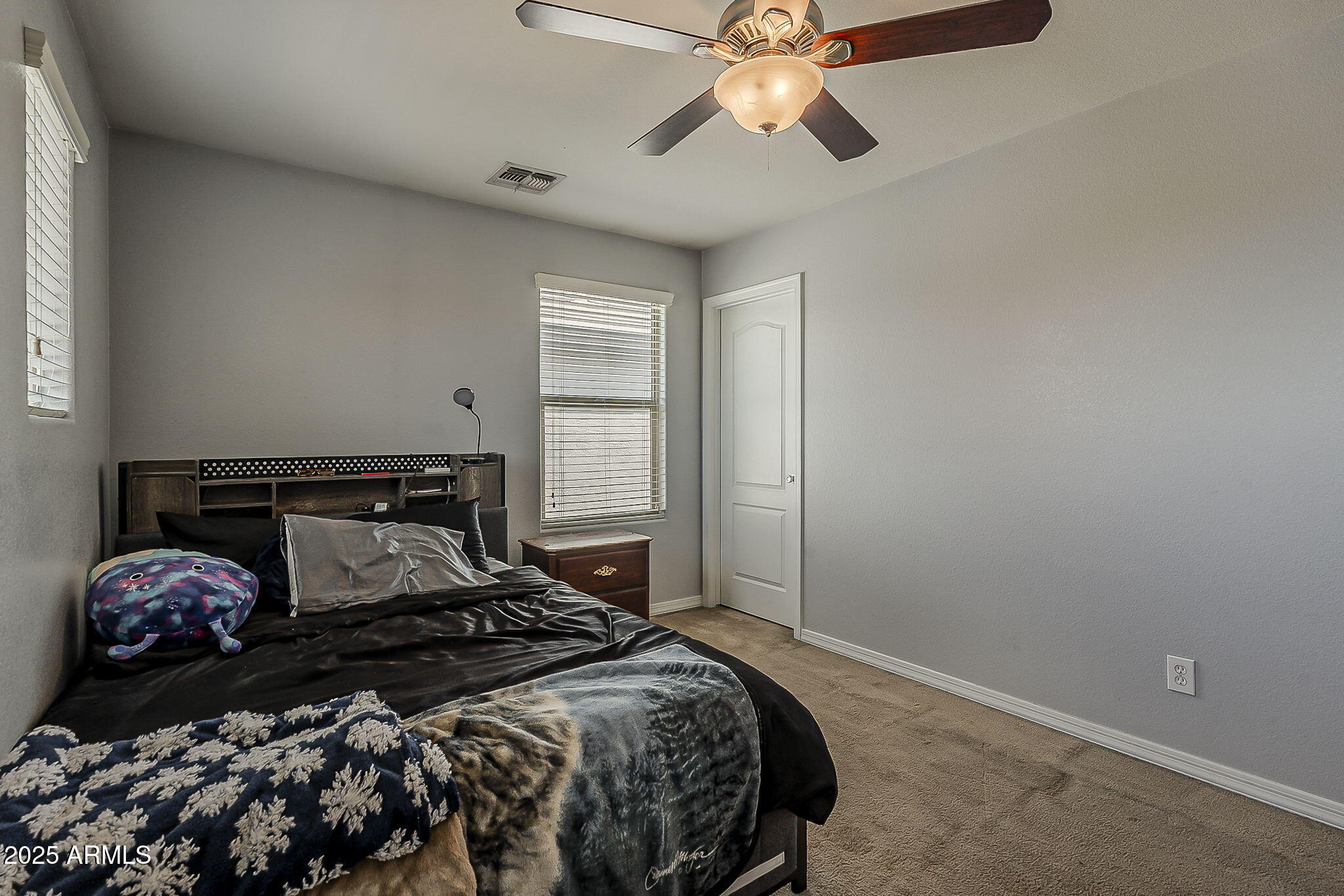 4407 West Crescent Road San Tan Valley, AZ 85144 - Photo 34 of 50 a bedroom with a bed and a chandelier