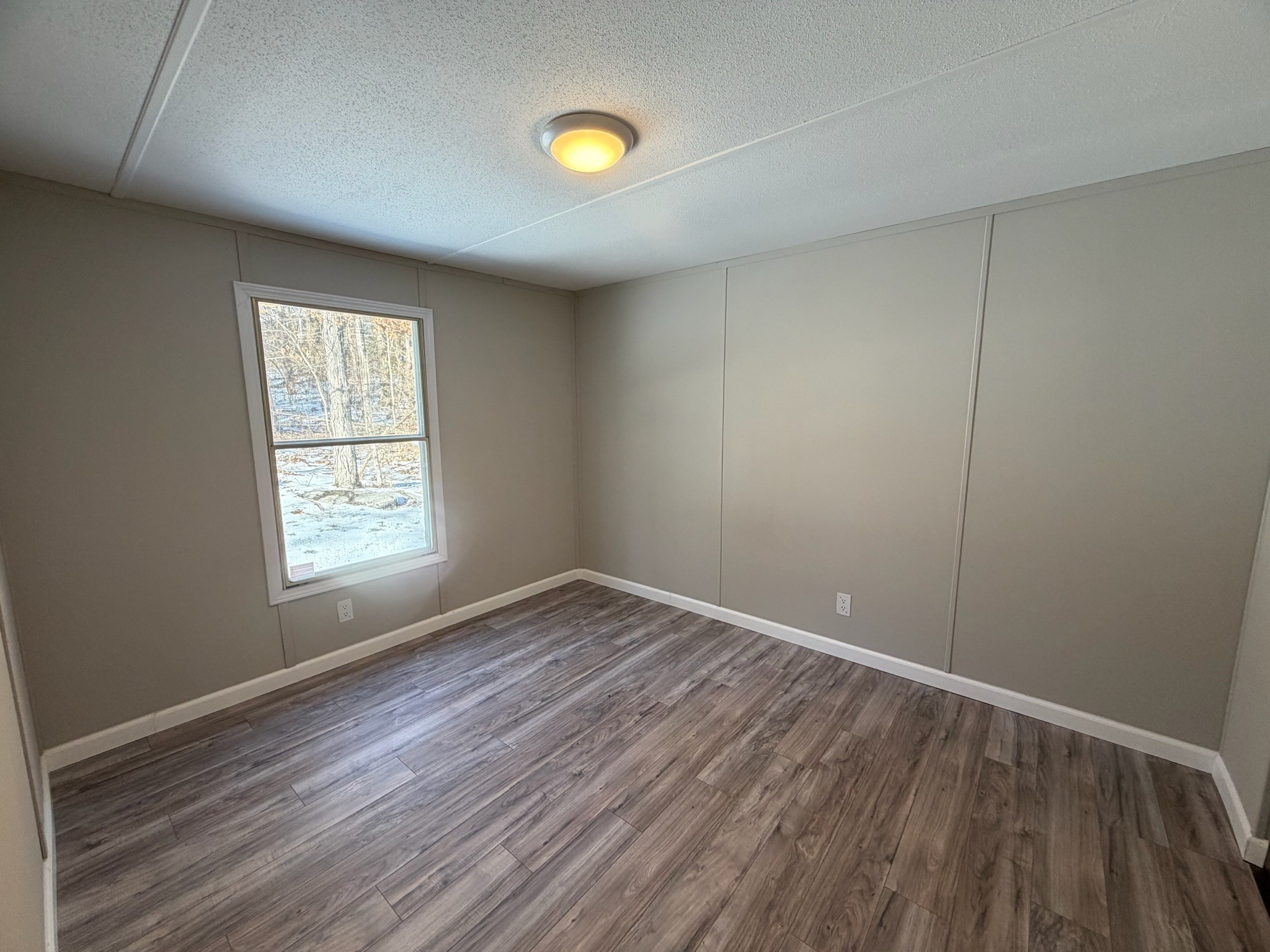 775 Slim Island Road Bowling Green, KY 42101 - Photo 12 of 17 an empty room with wooden floor and windows