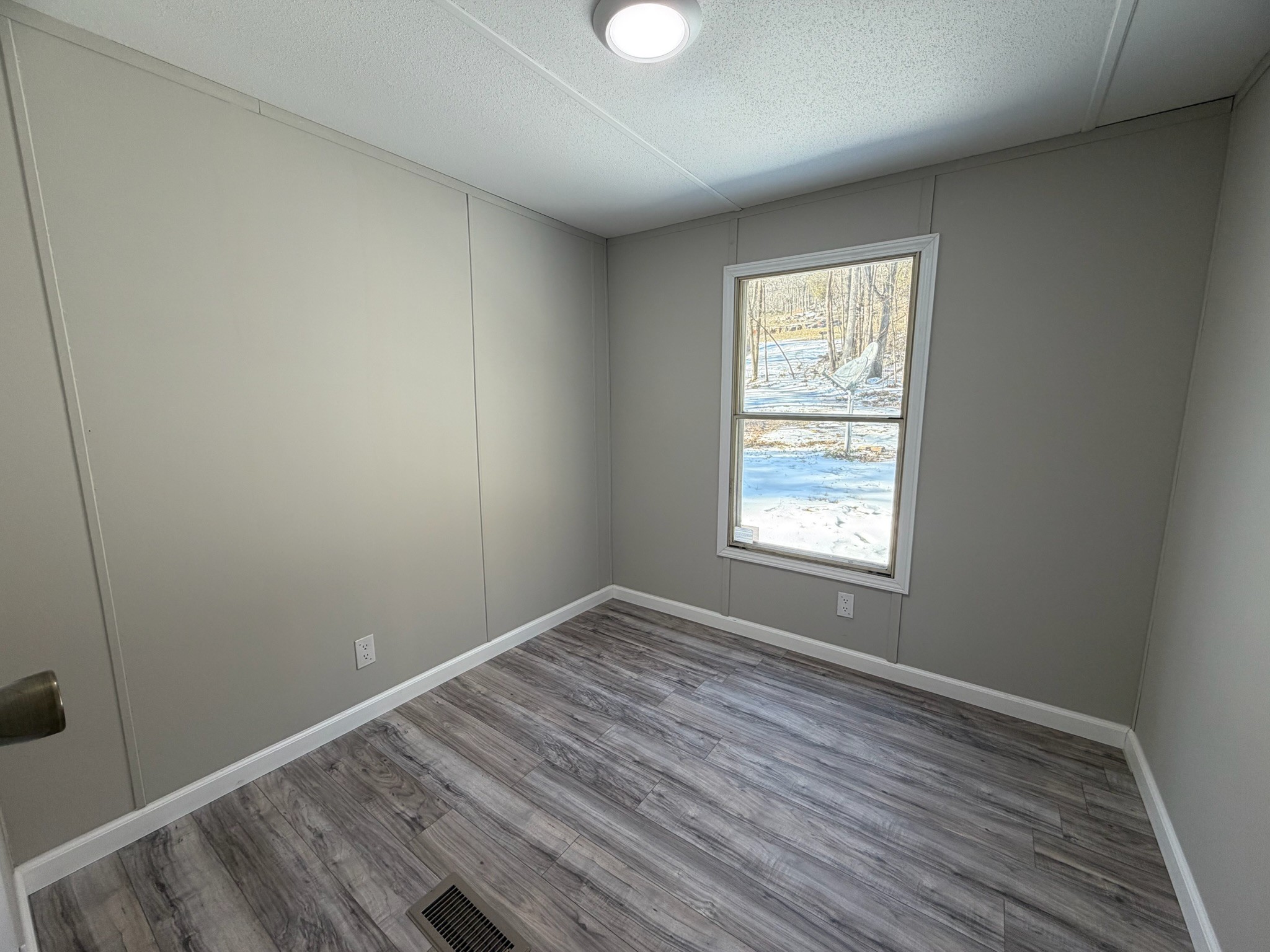 775 Slim Island Road Bowling Green, KY 42101 - Photo 9 of 17 an empty room with wooden floor and windows