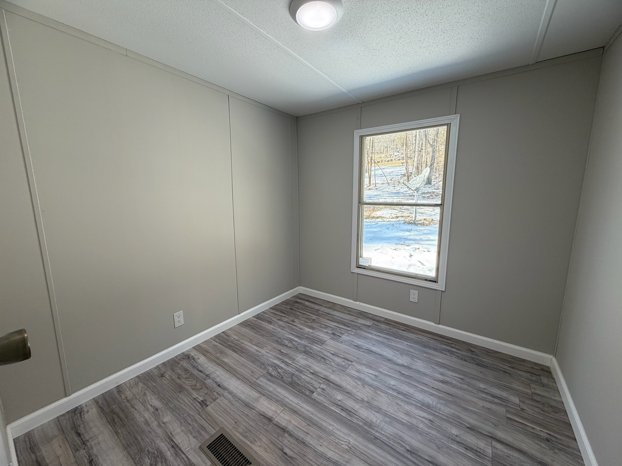 775 Slim Island Road Bowling Green, KY 42101 - Photo 10 of 17 an empty room with wooden floor and windows