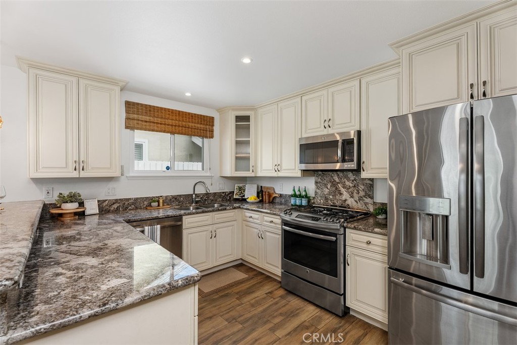 964 Lansing Lane Costa Mesa, CA 92626 - Photo 11 of 29 a kitchen with a stove a sink and a refrigerator