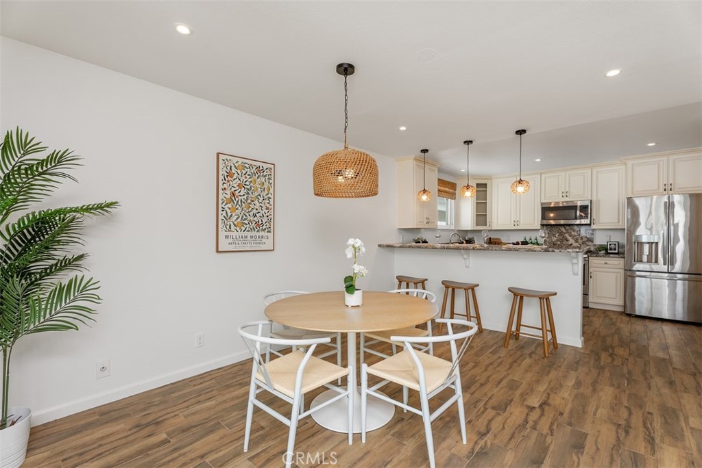 964 Lansing Lane Costa Mesa, CA 92626 - Photo 16 of 29 a view of a dining room with furniture and wooden floor