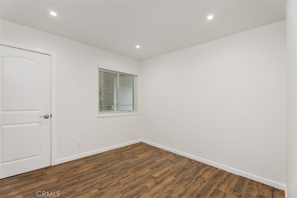 964 Lansing Lane Costa Mesa, CA 92626 - Photo 28 of 29 a view of empty room with wooden floor and fan