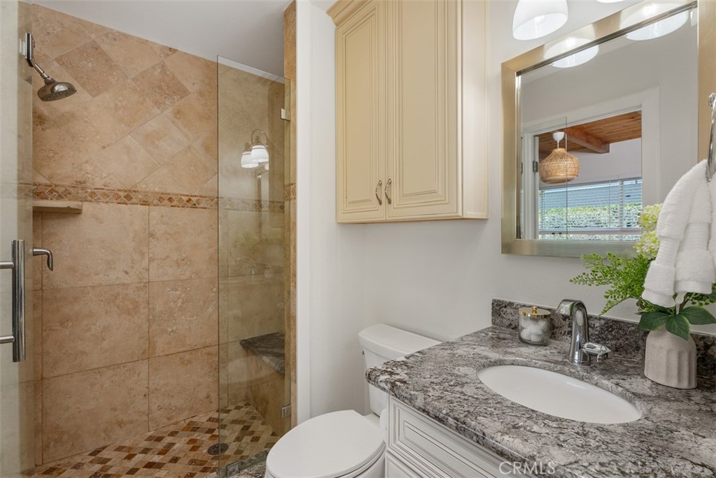 964 Lansing Lane Costa Mesa, CA 92626 - Photo 7 of 29 a bathroom with a granite countertop sink toilet a mirror and shower