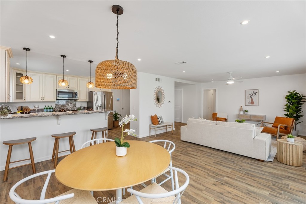 964 Lansing Lane Costa Mesa, CA 92626 - Photo 8 of 29 a living room with furniture a dining table and a chandelier