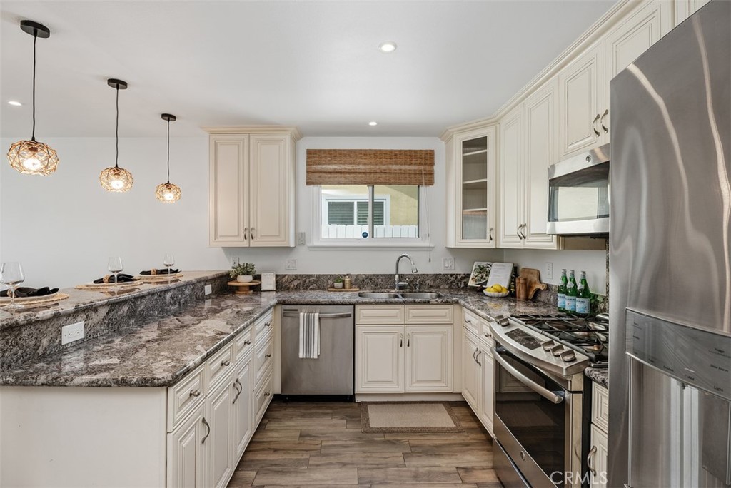 964 Lansing Lane Costa Mesa, CA 92626 - Photo 9 of 29 a kitchen with stainless steel appliances granite countertop a sink stove and refrigerator