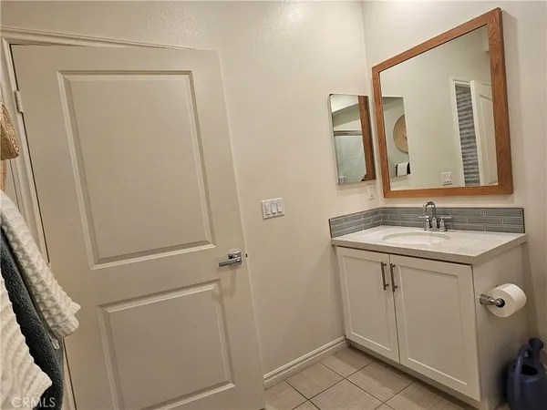 a bathroom with a toilet mirror and shower