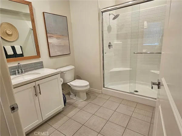 a view of a hallway with wooden floor and a potted plant