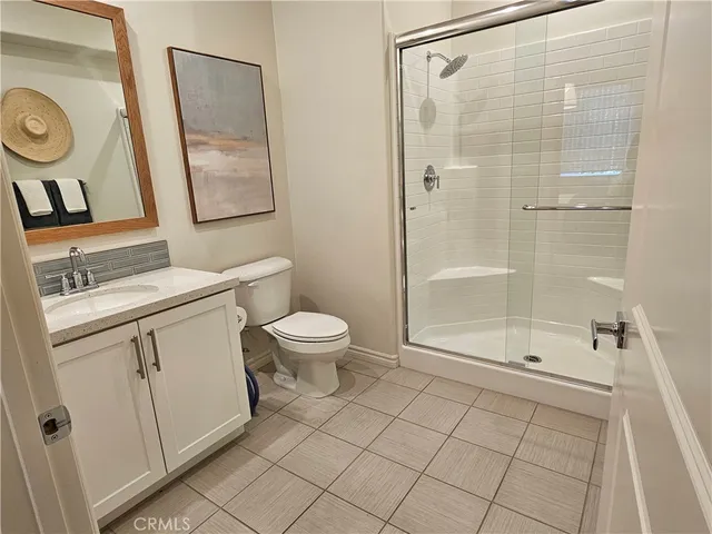 a view of a hallway with wooden floor and a potted plant